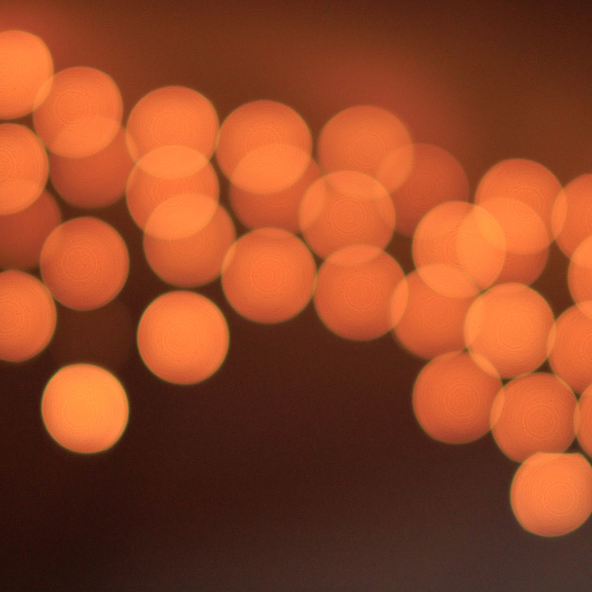 Warm orange lights softly blurred against a dark background
